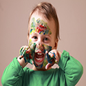 Child with face paint on it's face and hands